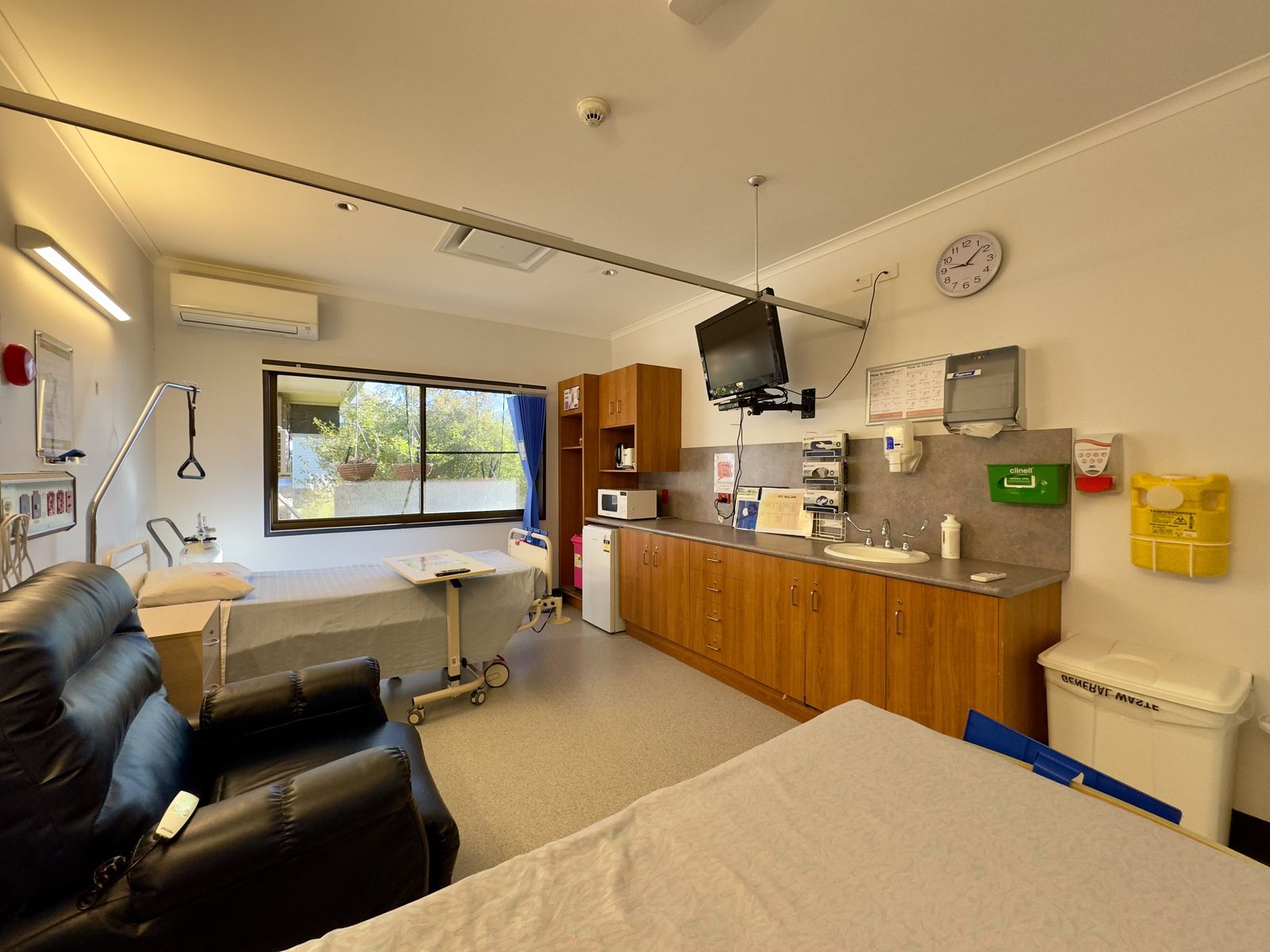 A single patient room at Quilpie Hospital, Queensland, with a hospital bed, a recliner chair and a basin